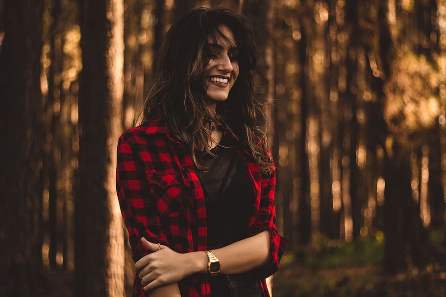shallow focus photography of woman in red checkered button-up top, woman in black and red flannel shirt shallow focus photography