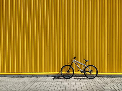 gray and black bike leaning on wall, bicycle leaning on yellow intermodal container HD wallpaper