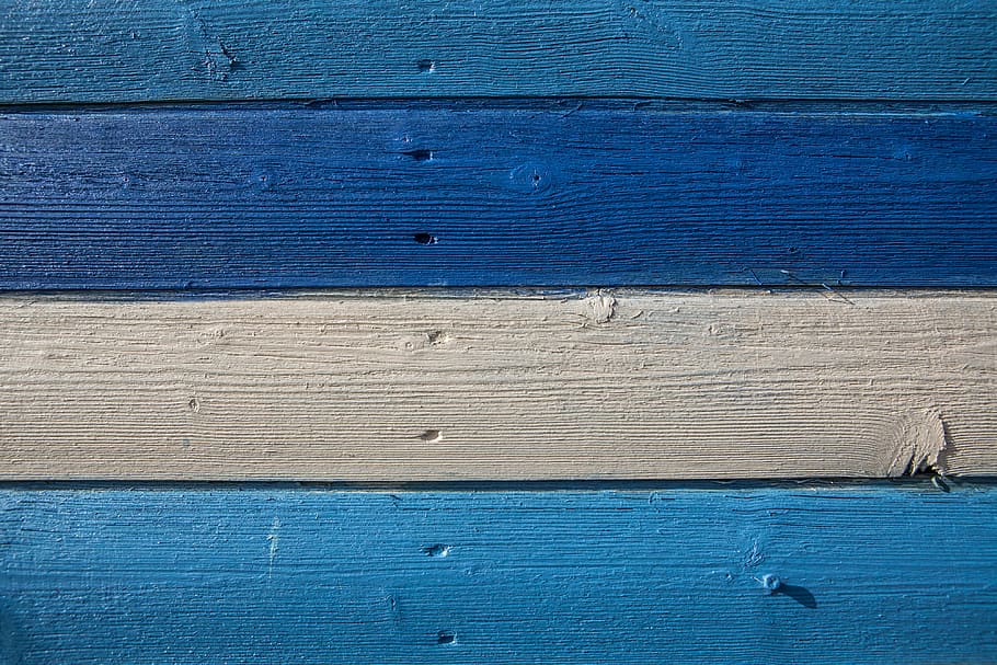 Close-up shot of blue and cream coloured wood panels, image captured in Kent, England