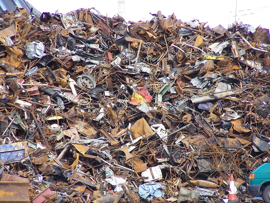 pile of scrap metals, garbage, dump, tall, city, buildings, outdoor