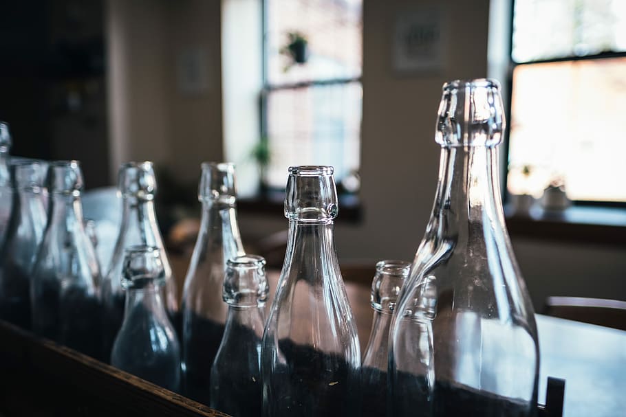 photography of glass bottles, selective focus photography of clear wine bottle lot HD wallpaper