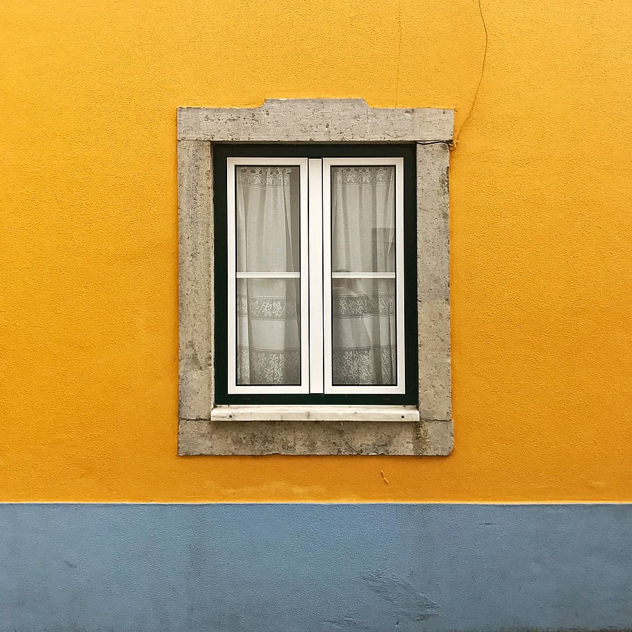 photo of white windowpane against yellow wall, glass panel window with white frame