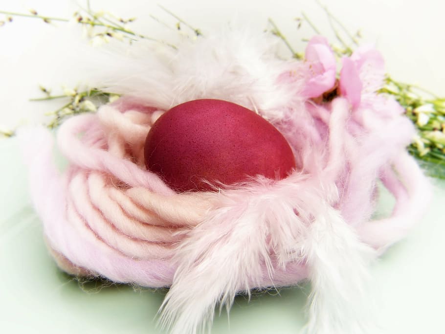 red egg covered by pink rope, easter nest, wool, color, dye eggs