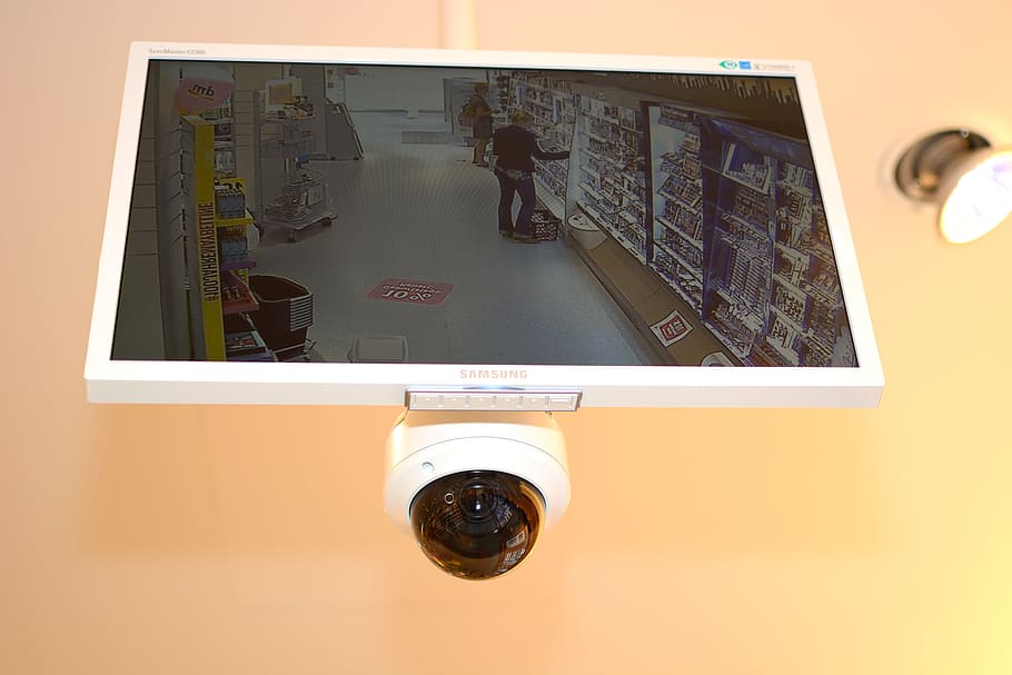 white Samsung flat screen CCTV monitor with turned-on screen