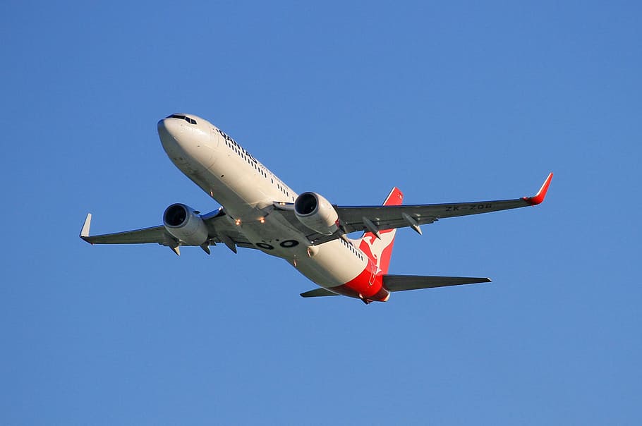 red and white passenger plane flying under blue clear sky during daytime, HD wallpaper