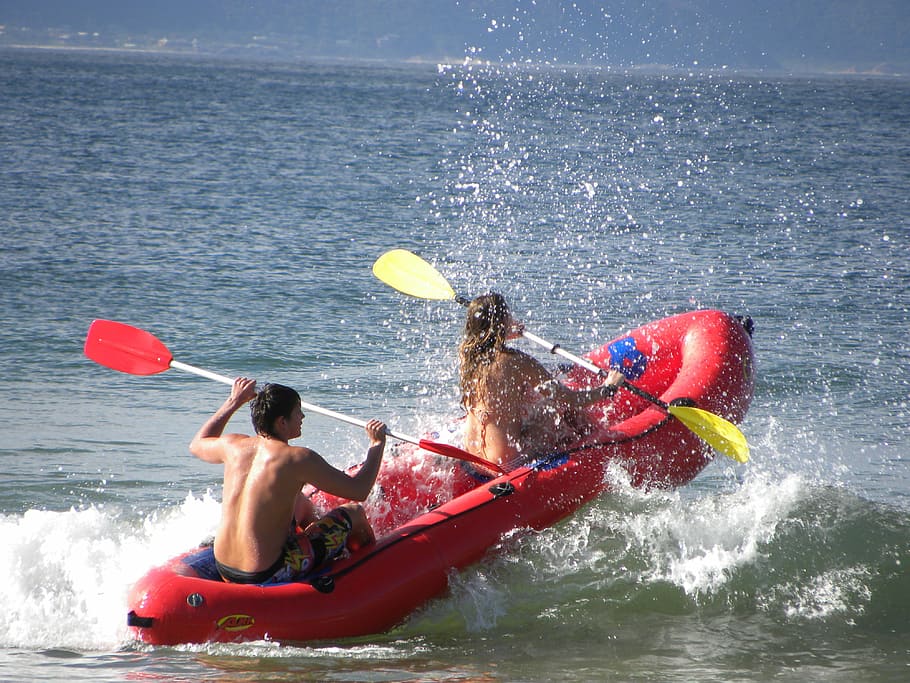 man and woman paddling in inflatable boat, rafting, rubber boat
