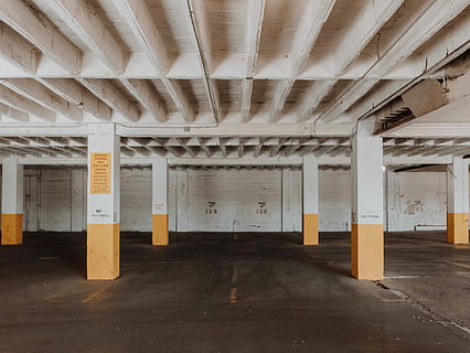 white and brown underground parking area, parking lot with concrete post HD wallpaper