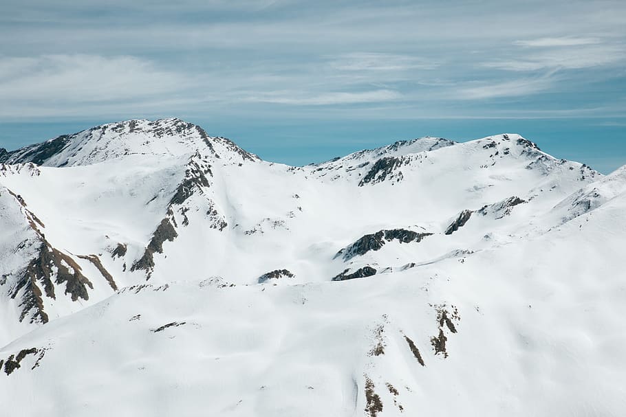 mountain covered by snow under blue sky, photo of snowy mountain during daytime HD wallpaper