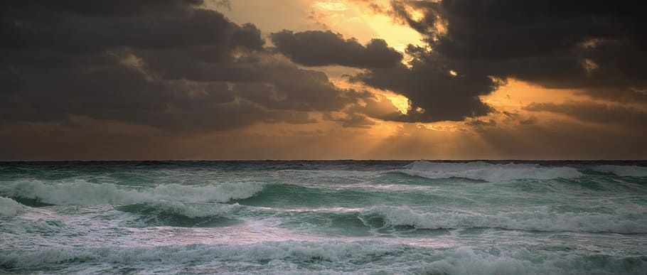 photography of ocean waves during golden hour, seawaves under cloudy sky during daytime