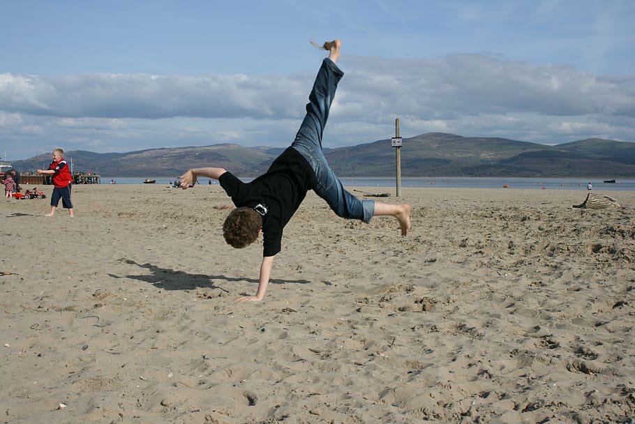 child cartwheeling on seashore, boy, beach, handstand, gymnastics, HD wallpaper