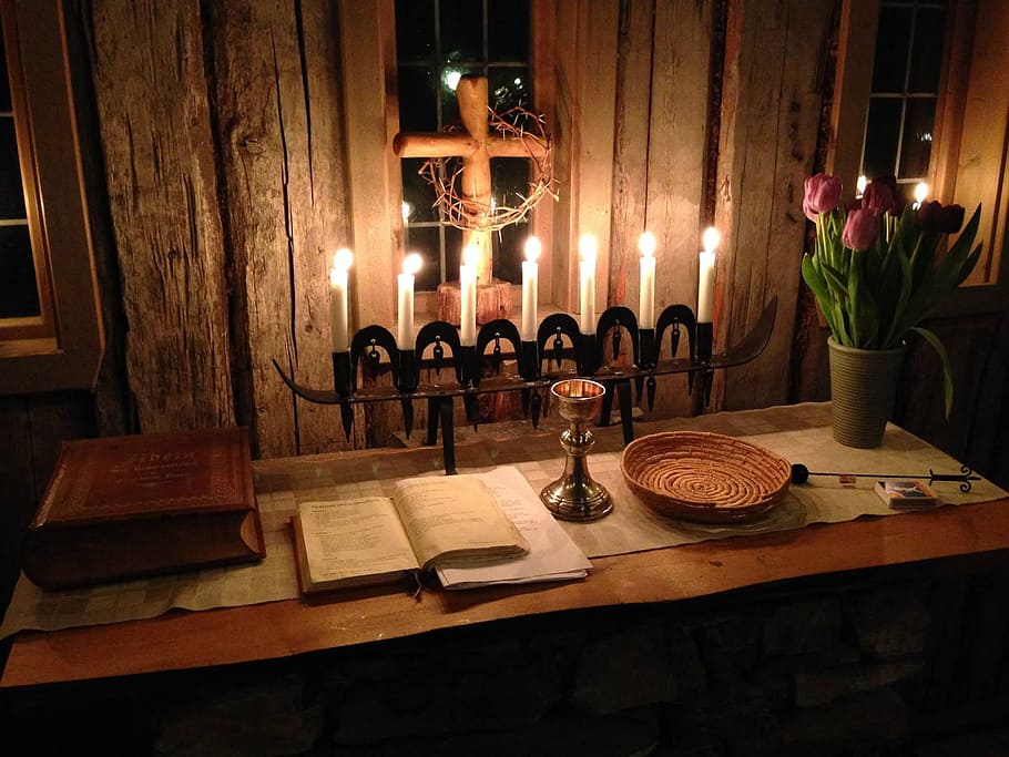 black metal candle holders near brown wooden desk inside room
