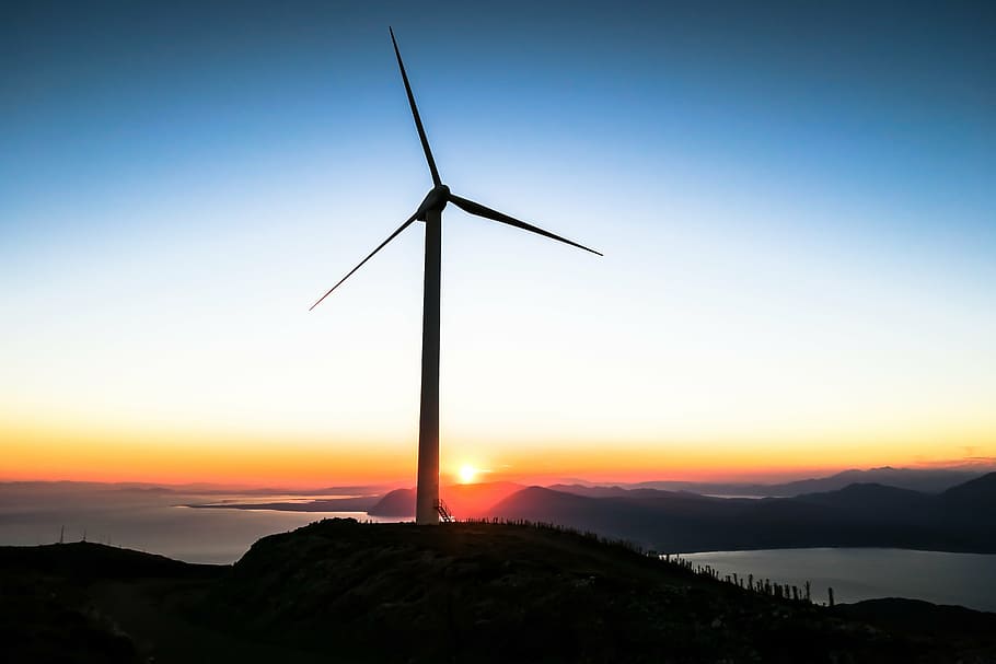 photo of wind mill near sea under clear blue sky during daytime HD wallpaper
