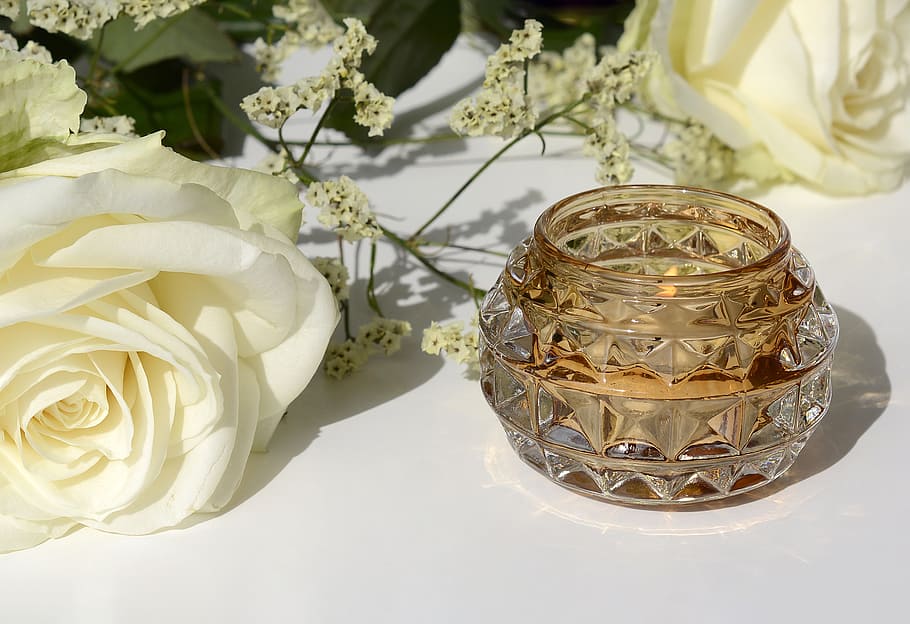 white rose and baby's breath flowers beside a crystal candle holder HD wallpaper