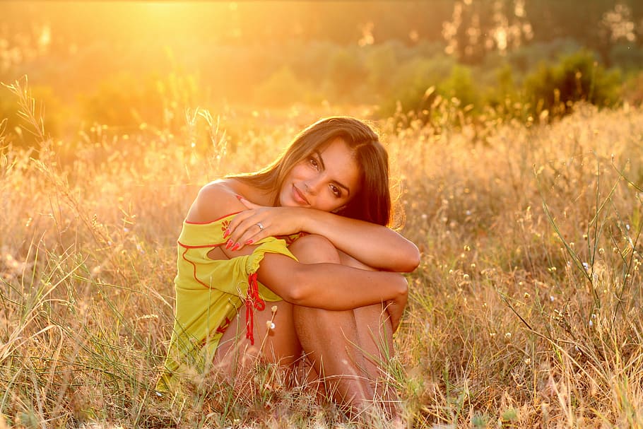 woman in yellow dress sitting on green grass during daytime HD wallpaper