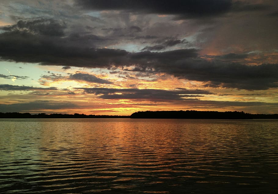 silhouette photo of islet, body of water under gray clouds, sunset HD wallpaper