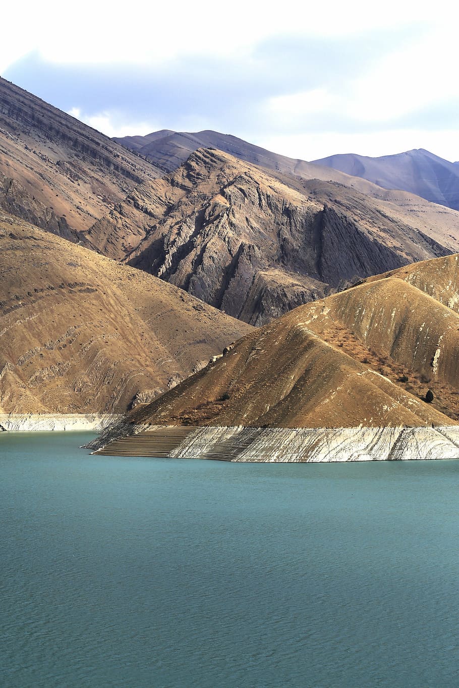 brown mountains near body of water, mountain terrain near body of water HD wallpaper