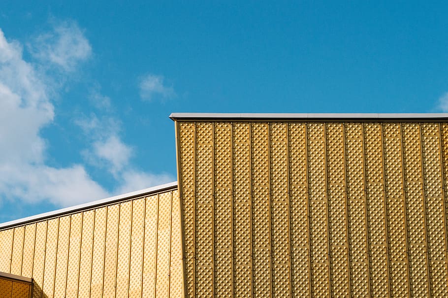 Berliner Philharmonie, brown building under blue sky low-angle photography