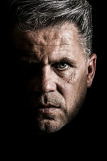 close-up of a man's face against black background, human, portrait HD wallpaper