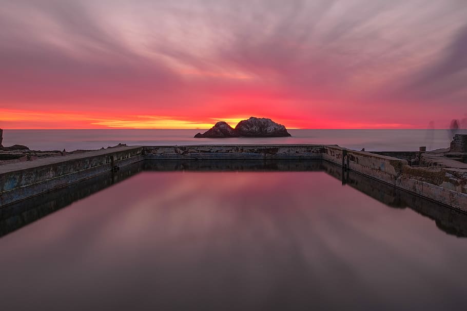 landscape photography of rock formation on body of water, rock formation surrounded by body of water HD wallpaper