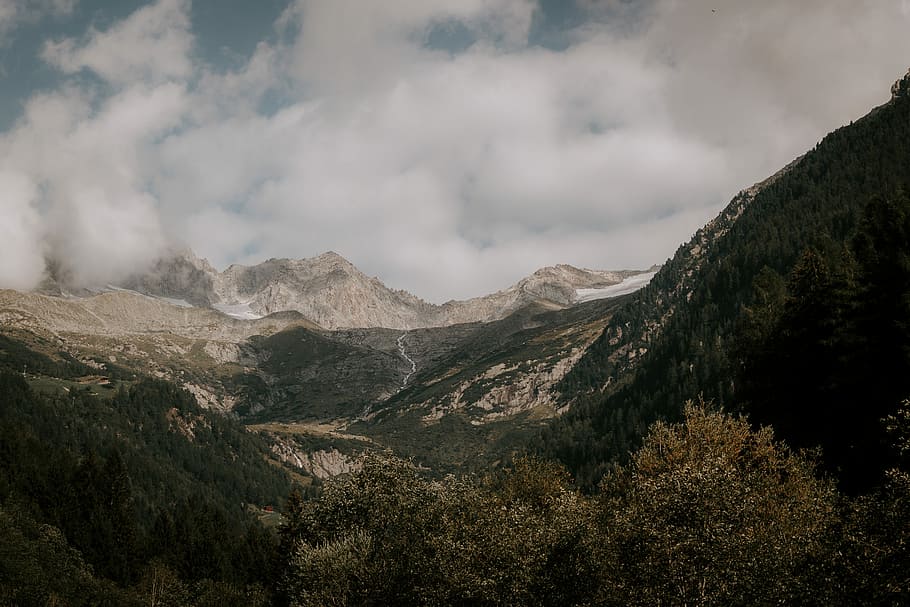 brown mountain under white sky, aerial view photography of mountains under cloudy sky during daytime HD wallpaper