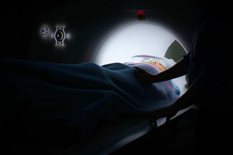 person lying on ct-scan machine, person lying on CT scan machine