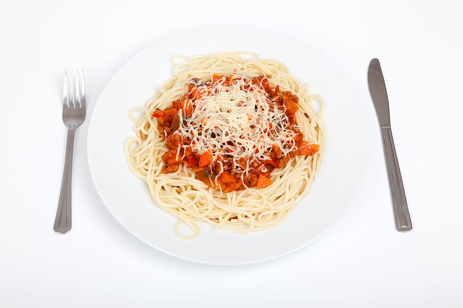 flay lay photography of spaghetti with knife and fork on sides