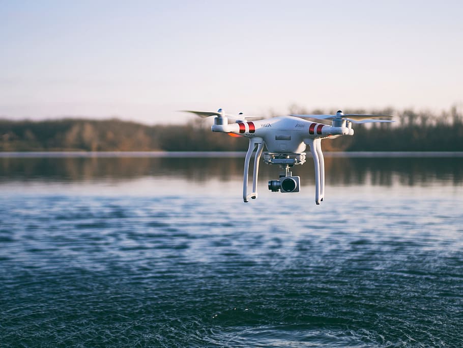 red and white DJI Phantom 3 flying over body of water during daytime, HD wallpaper