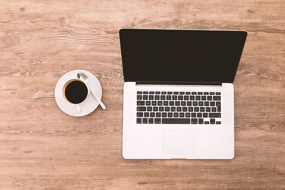black and gray MacBook pro with white ceramic coffee mug, laptop HD wallpaper