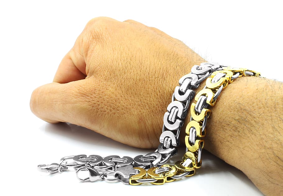 person wearing two silver-and-gold-colored bracelets, Stainless
