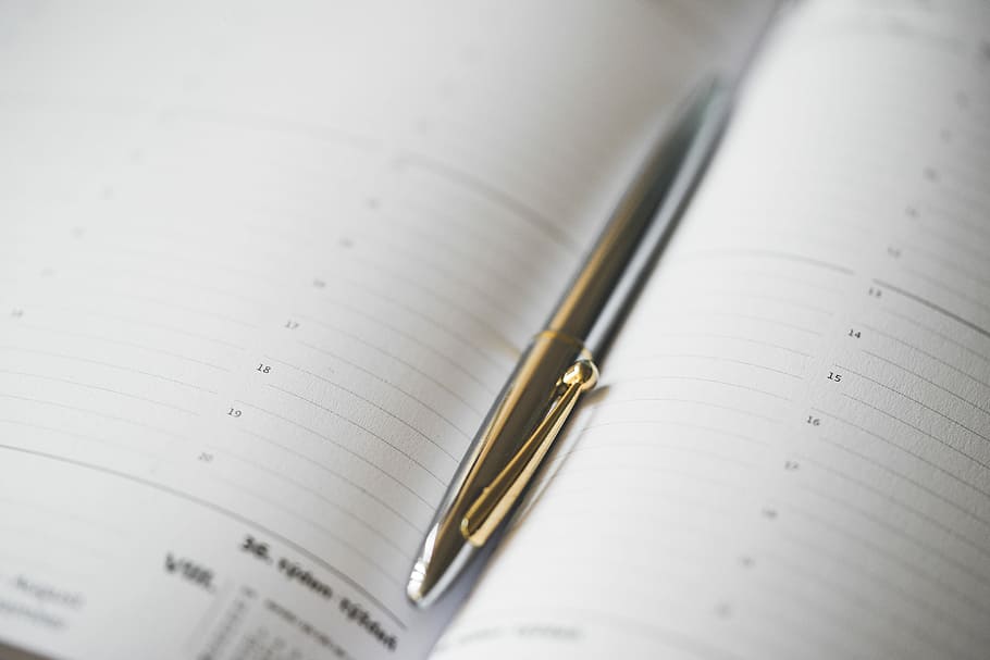 Silver Pen in Open Business Day Planner Diary, agency, black