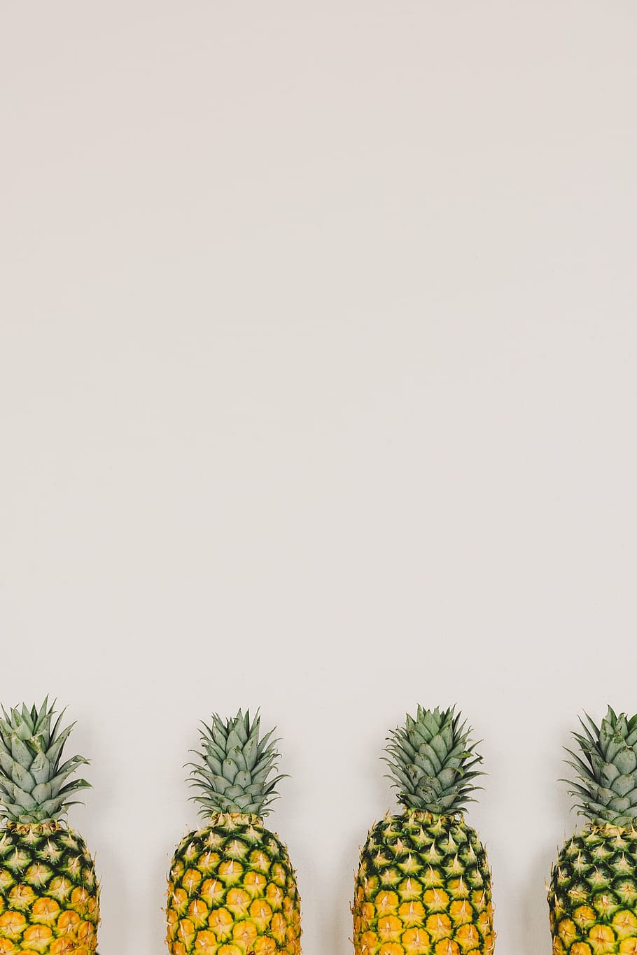 four yellow pineapple fruits leaning on white wall, dessert HD wallpaper