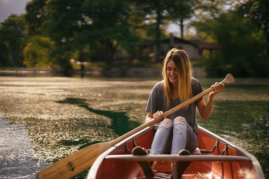 HD wallpaper: woman sitting in brown paddle boat, woman rowing boat at ...