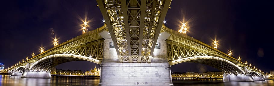 lighted full-suspension bridge over body of water at night time, low-angle photography of bridge near body of water, HD wallpaper