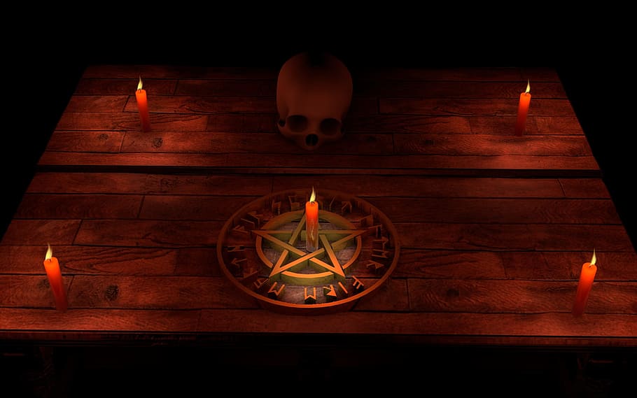 five red candles, brown pentagram, and human skull, pentacle