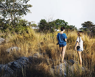 two women standing on brown field, active, adventure, backpack HD wallpaper