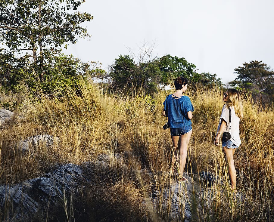 two women standing on brown field, active, adventure, backpack HD wallpaper