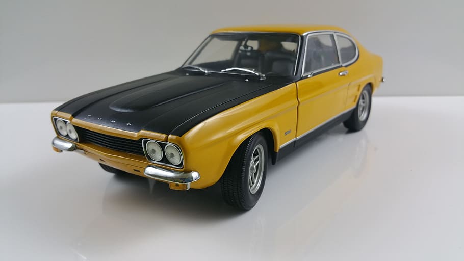 yellow and black coupe die-cast model displayed on tabletop HD wallpaper