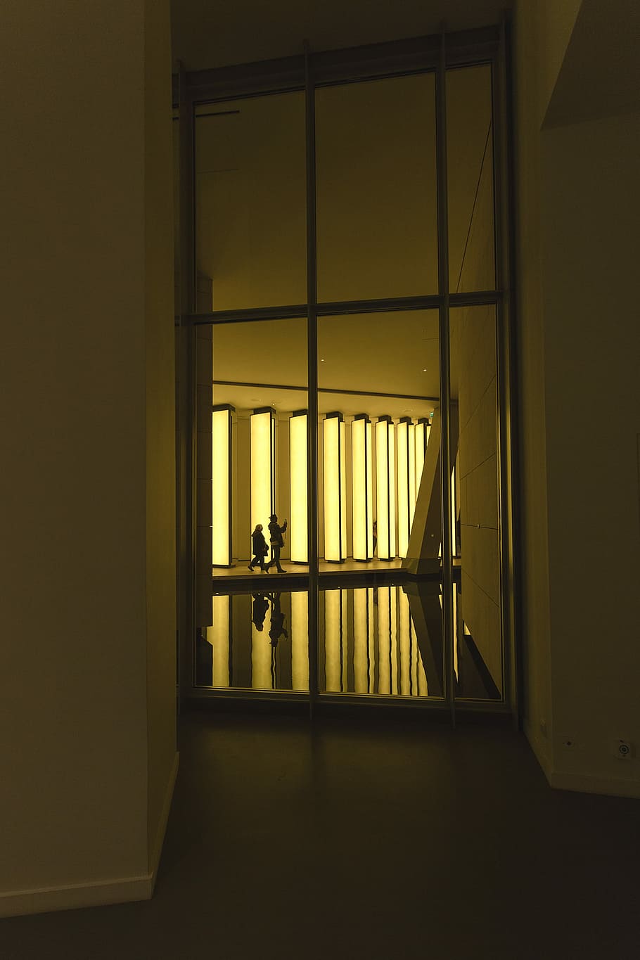 silhouette of two persons walking inside building during golden hour, brown wooden 6-lite window inside room HD wallpaper