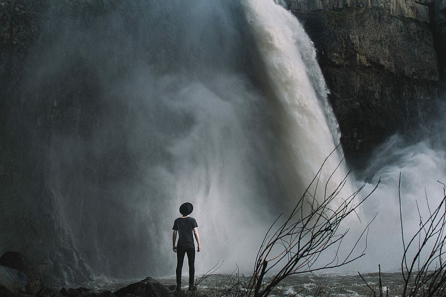 boy standing near waterfalls, branches, gray, men, rocks, nature HD wallpaper