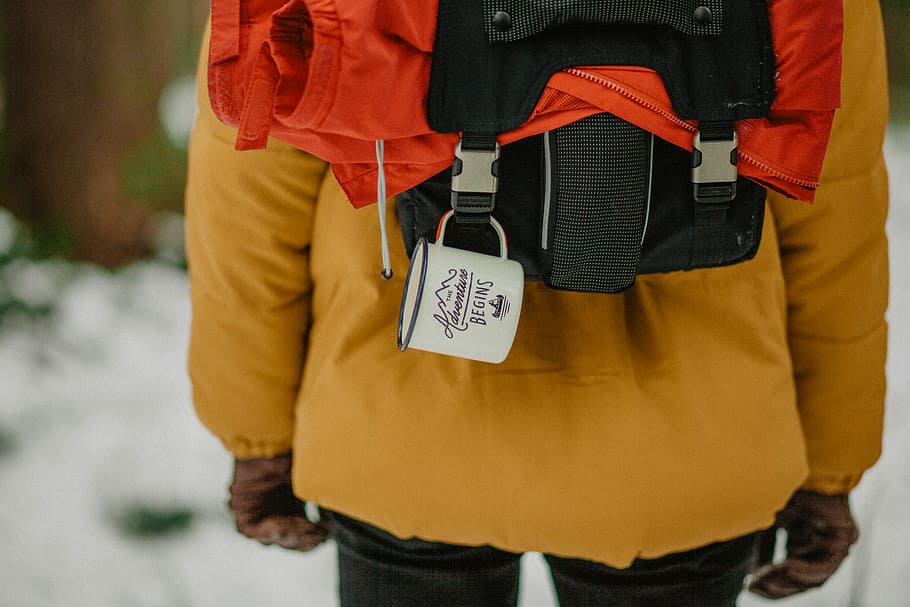 selective focus photograph of person wearing orange coat and black backpack, untitled HD wallpaper