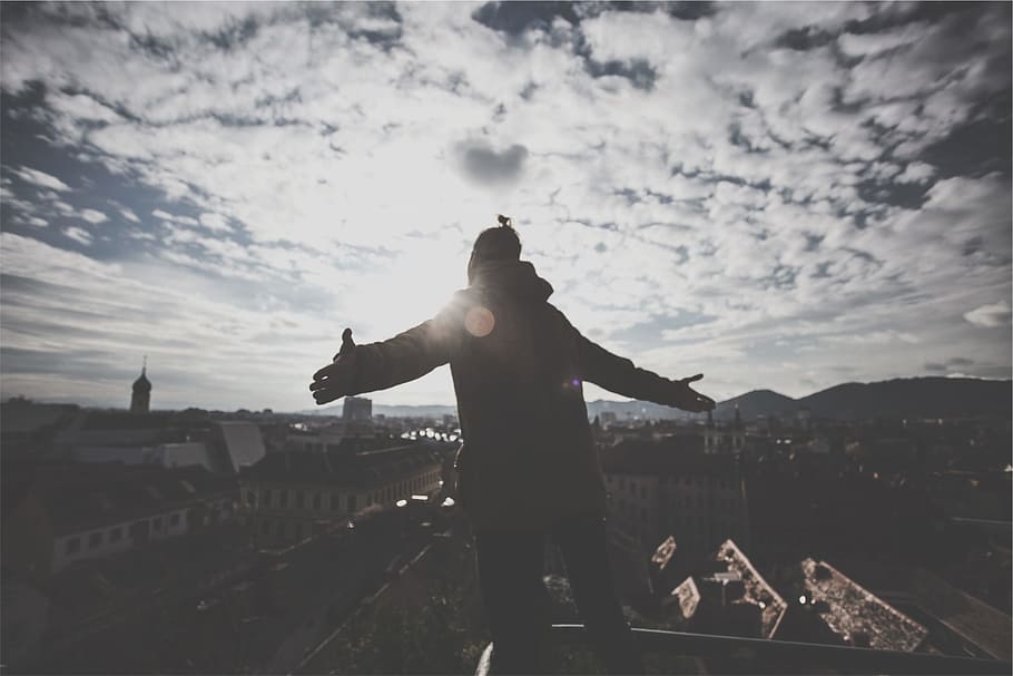 sun rays, man, guy, sky, clouds, buildings, city, view, rooftops HD wallpaper
