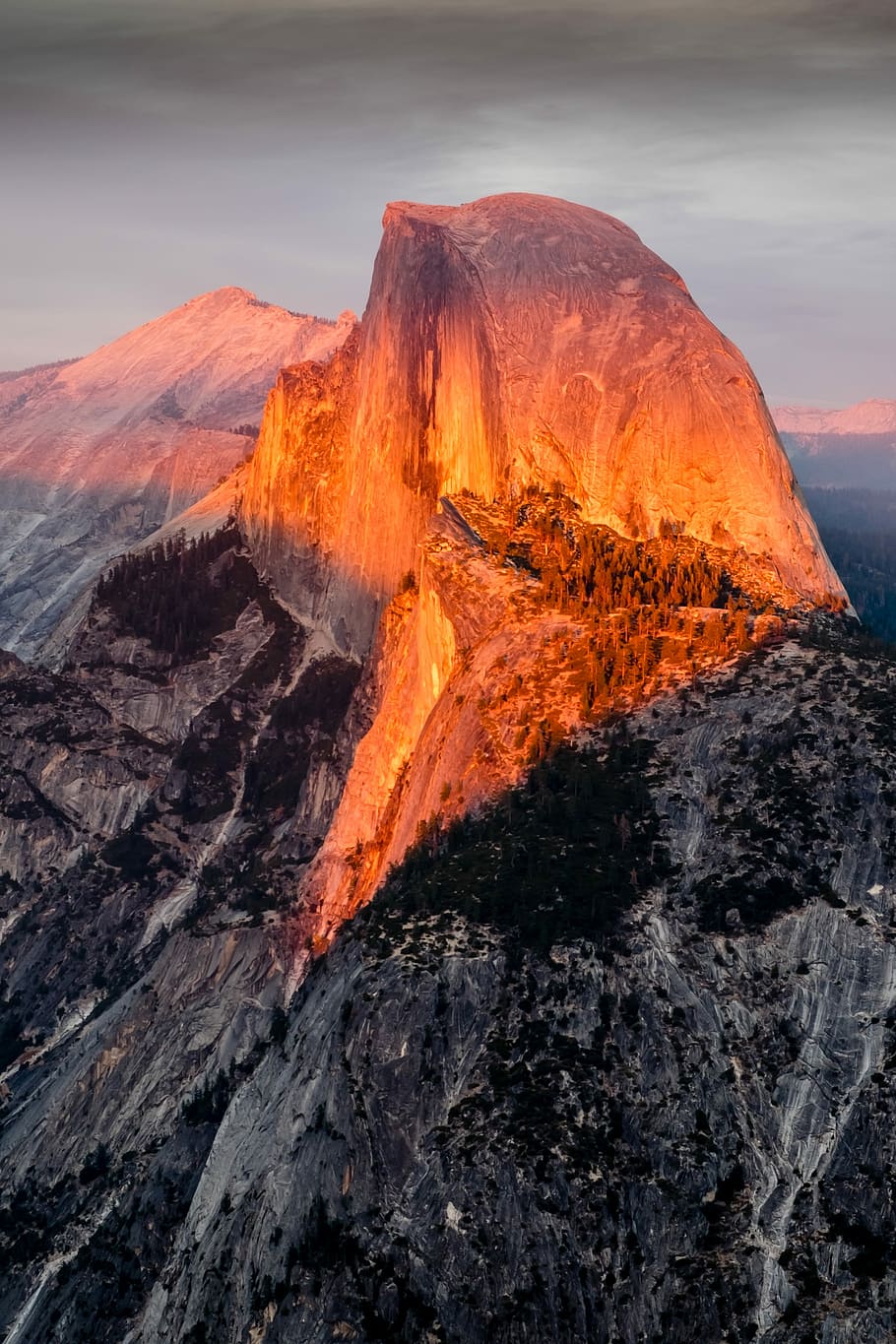 photo of sun light on mountain peak, brown and gray mountains under gray clouds HD wallpaper