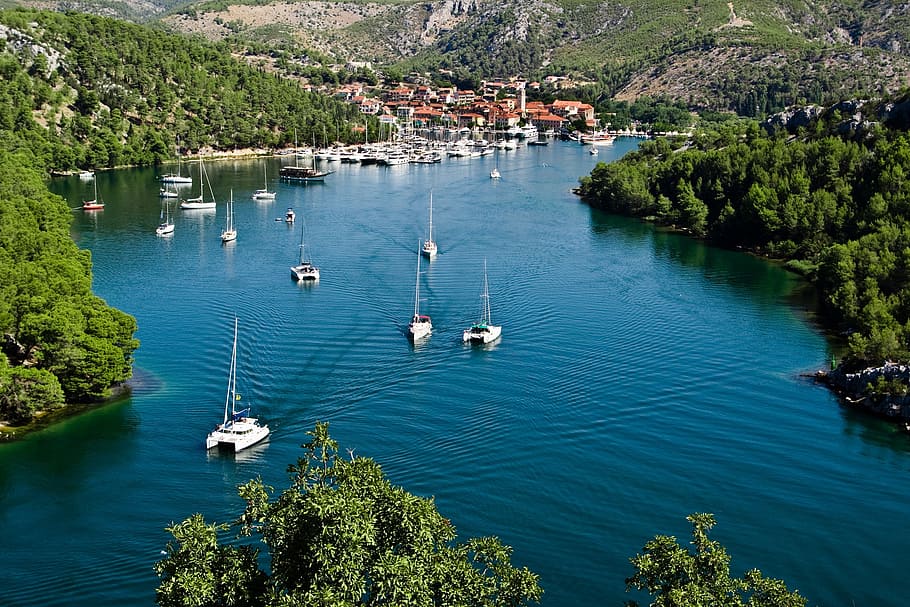 yacht on body of water surrounded by trees, croatia, blue, europe