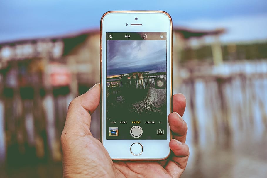 iPhone displaying camera, apple, hand, macro, mobile phone HD wallpaper
