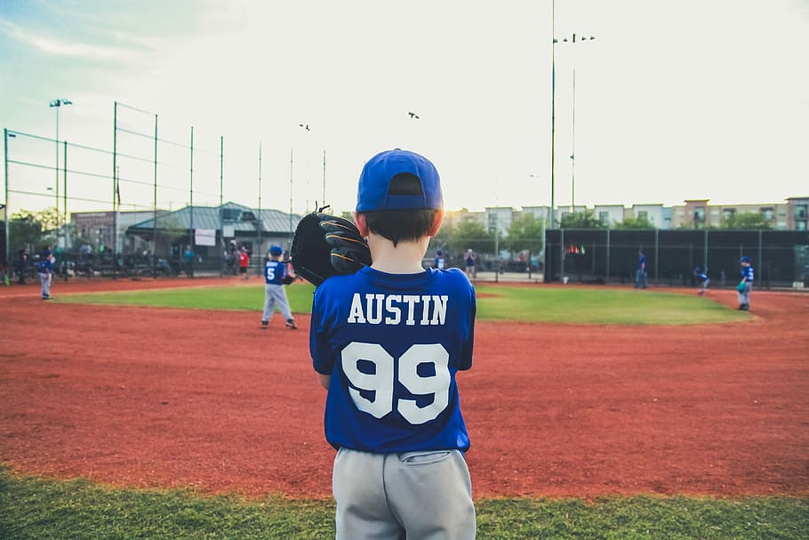 boy in blue and white shirt standing on green grass, boy wearing blue Austin 99 jersey, HD wallpaper