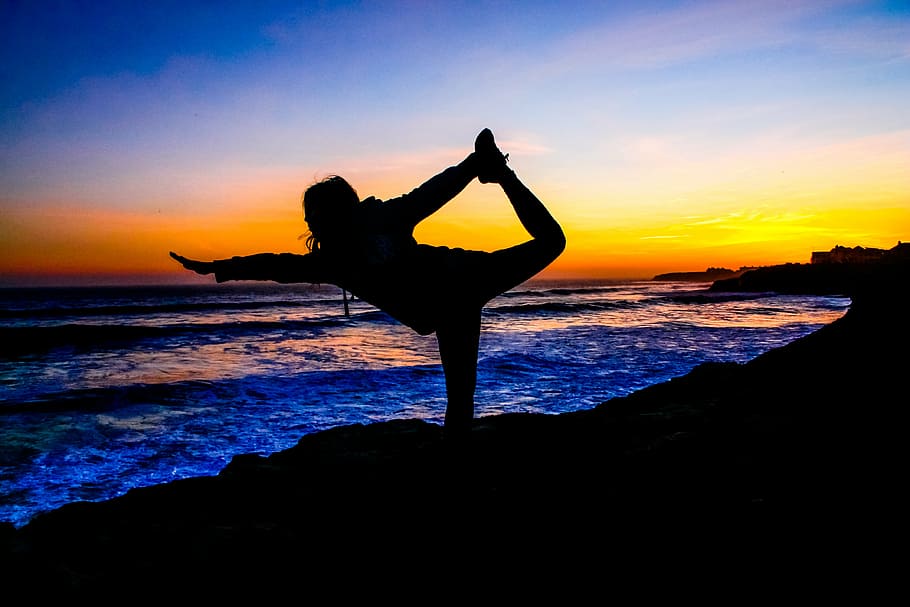 silhouette photo of woman doing yoga during sunset, pacific, healthy