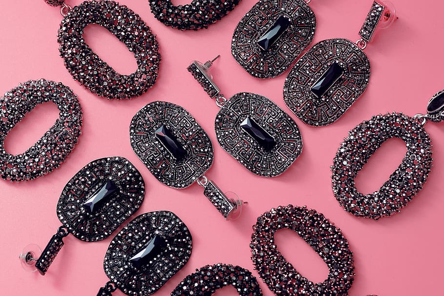 black gemstone pendants on pink surface, assorted embellished pendant lot HD wallpaper