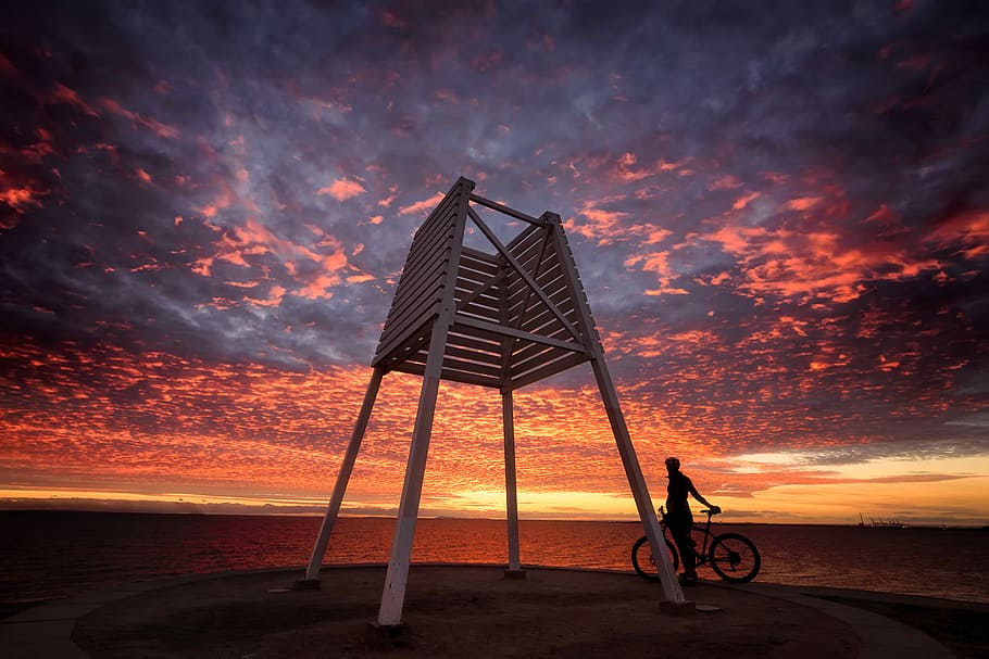 brown lifeguard chair, low angel photography of lifeguard chair under golden hour HD wallpaper
