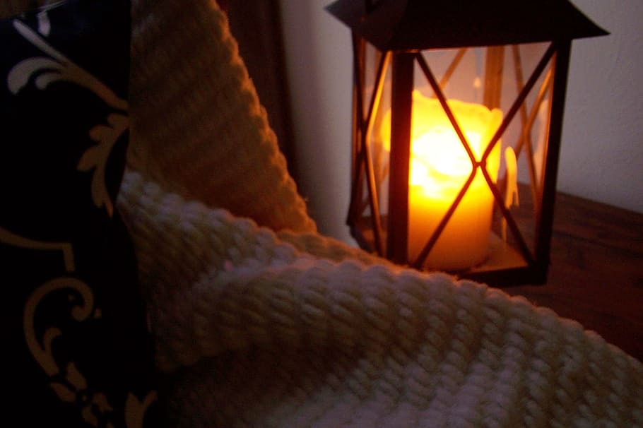 white pillar candle in black candle lantern, blanket, cozy HD wallpaper