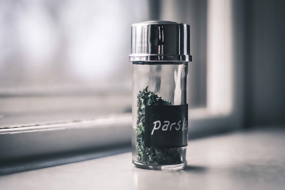 clear condiment shaker, green parsley bottle on white surface HD wallpaper